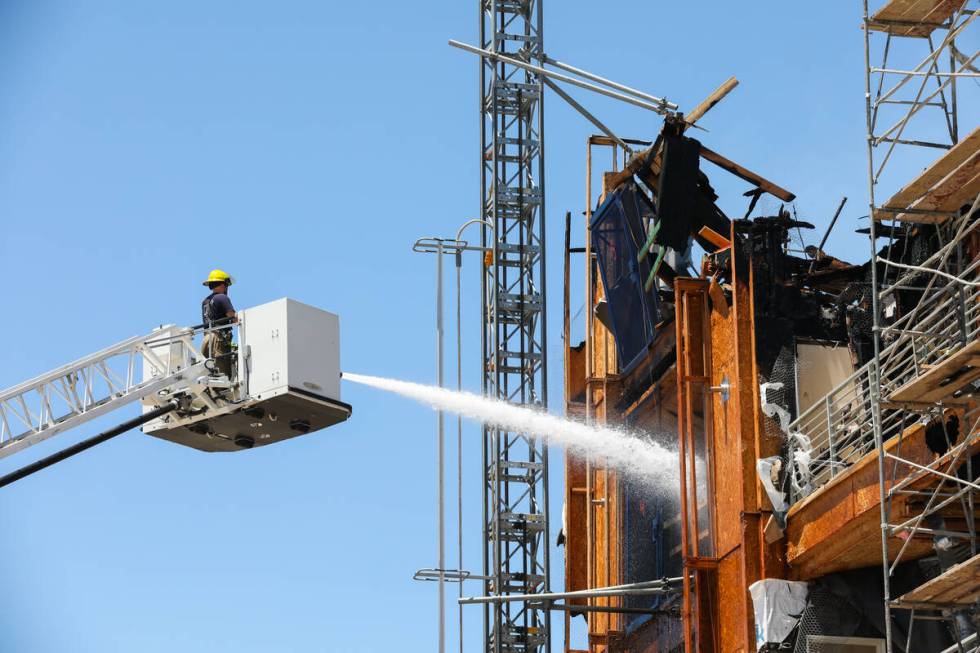 Firefighters work on a fire in an apartment complex under construction at 8030 W. Maule Ave on ...