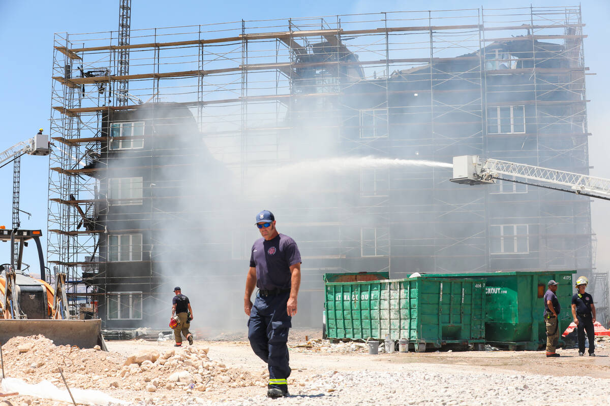 Firefighters work on a fire in an apartment complex under construction at 8030 W. Maule Ave on ...