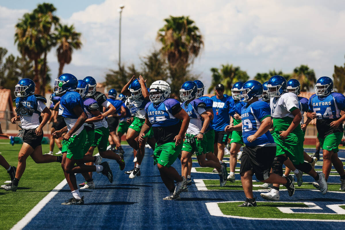 Green Valley football players run down the field during a drill at practice at Green Valley Hig ...