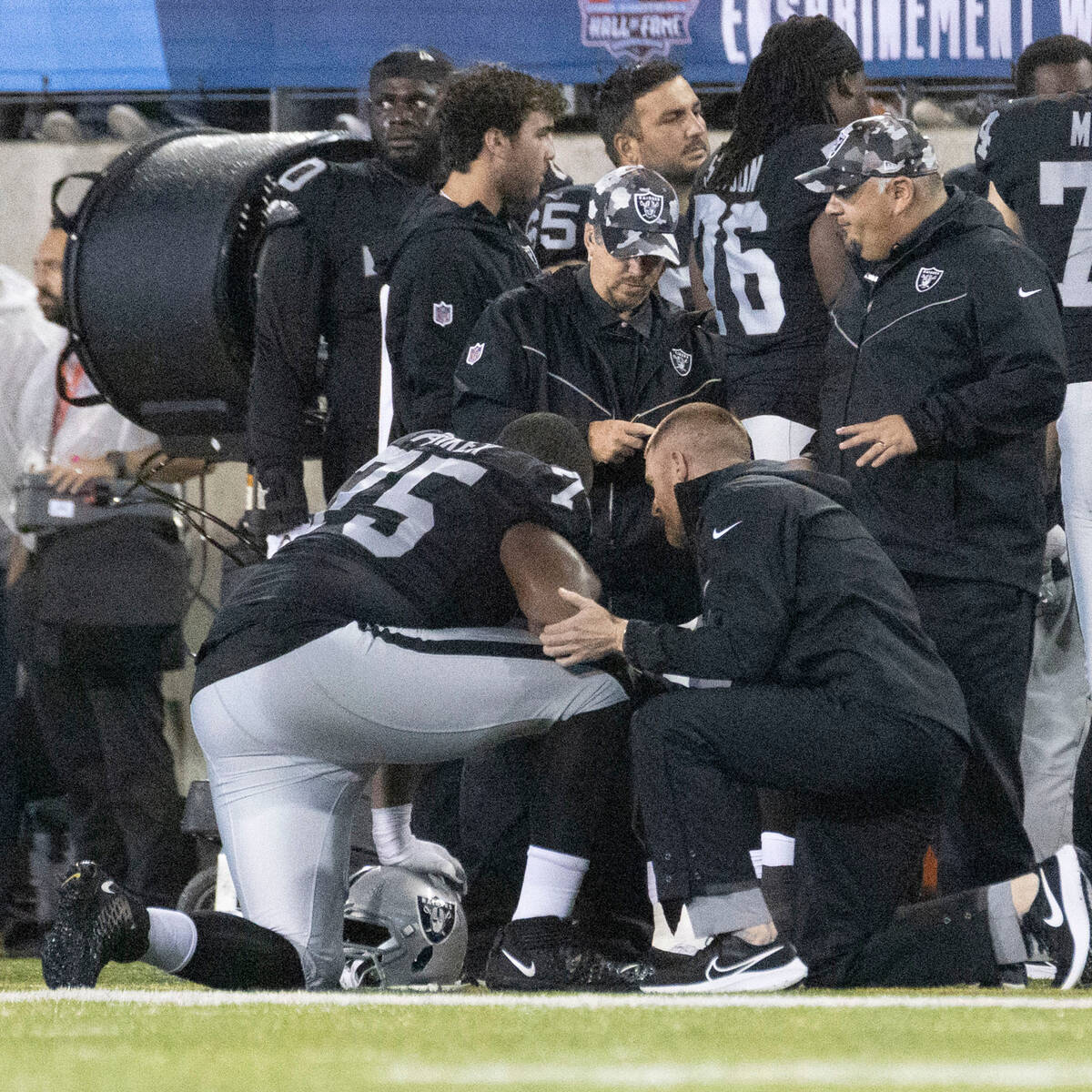 Raiders offensive tackle Brandon Parker (75) is examined by trainers during the first half of t ...