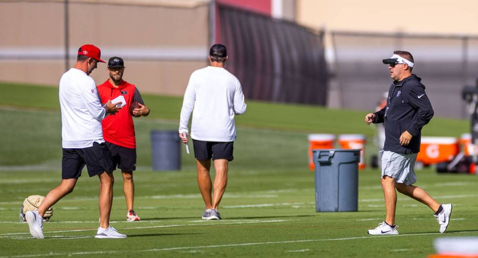 Raiders head coach Josh McDaniels runs over the San Francisco 49ers head coach Kyle Shanahan in ...