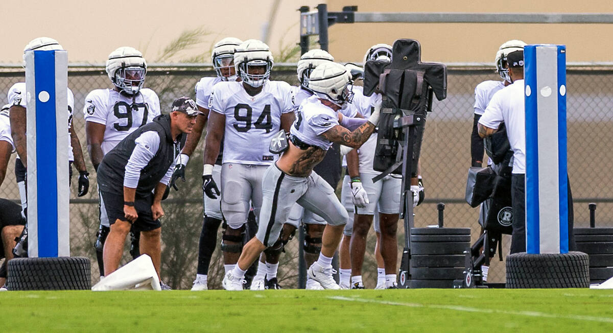 Raiders defensive end Maxx Crosby (98) strikes a dummy during training camp at the Intermountai ...