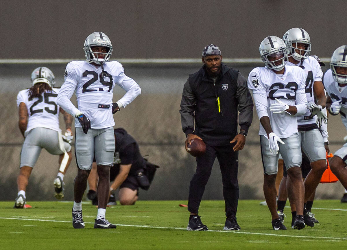 Raiders cornerback Jakorian Bennett (29), left, observes a drill for warmups during training ca ...