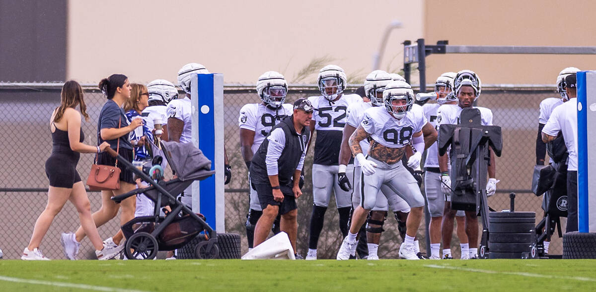 Raiders defensive end Maxx Crosby (98) looks for another after striking a dummy during training ...