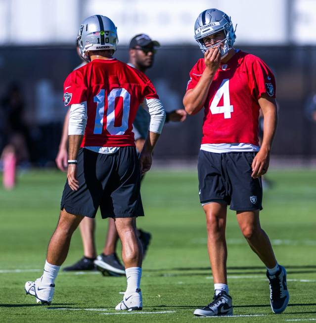 Raiders quarterback Aidan O'Connell (4) walks on the field as Jimmy Garoppolo (10) sets up to p ...