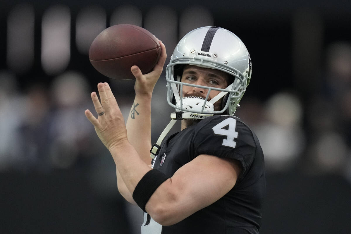 Las Vegas Raiders quarterback Derek Carr (4) warms up before an NFL football game against the N ...