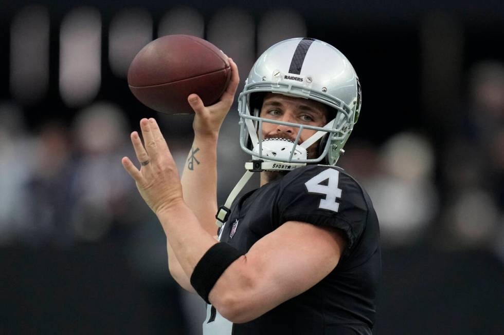 Las Vegas Raiders quarterback Derek Carr (4) warms up before an NFL football game against the N ...