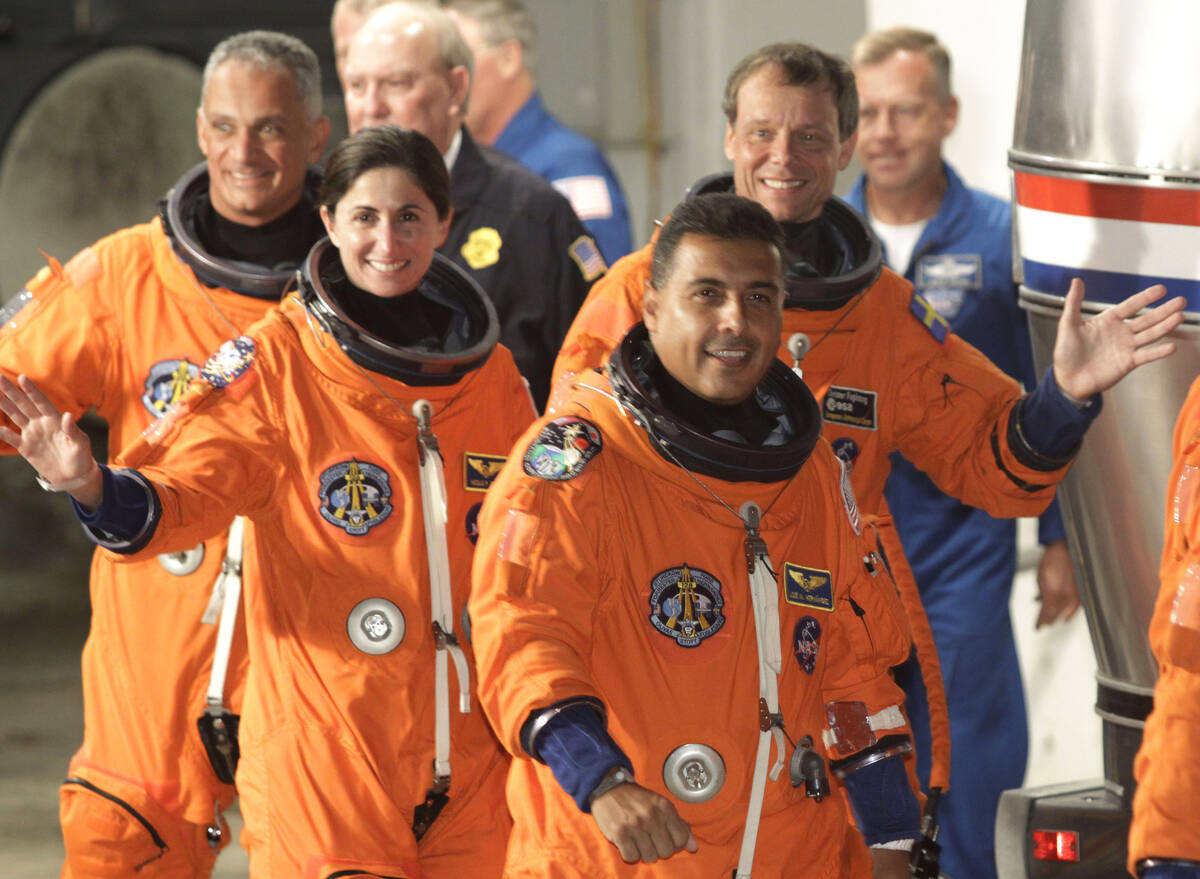 Space shuttle Discovery crew right to left: mission specialist Jose Hernandez, mission speciali ...