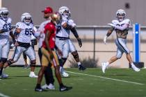 Raiders defensive end Maxx Crosby (98) leads the team in warmups during training camp before sc ...