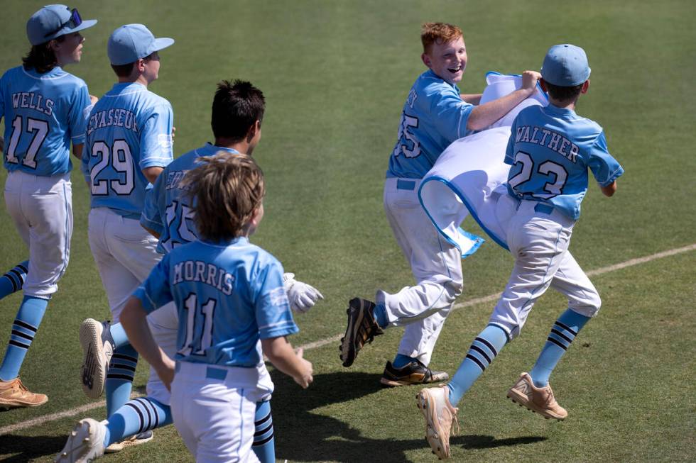 Henderson takes a lap around the field after winning the Little League West Regional final base ...