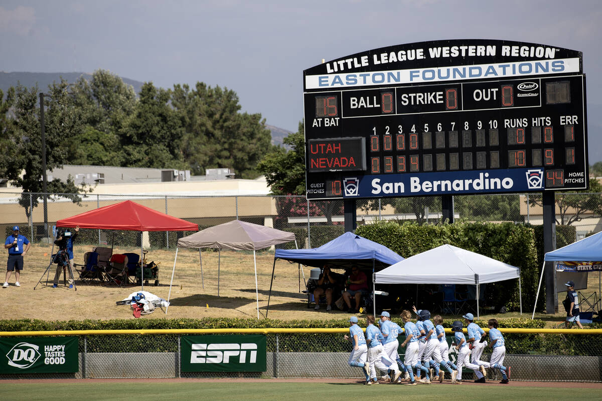 Henderson takes a lap around the field after winning the Little League West Regional final base ...