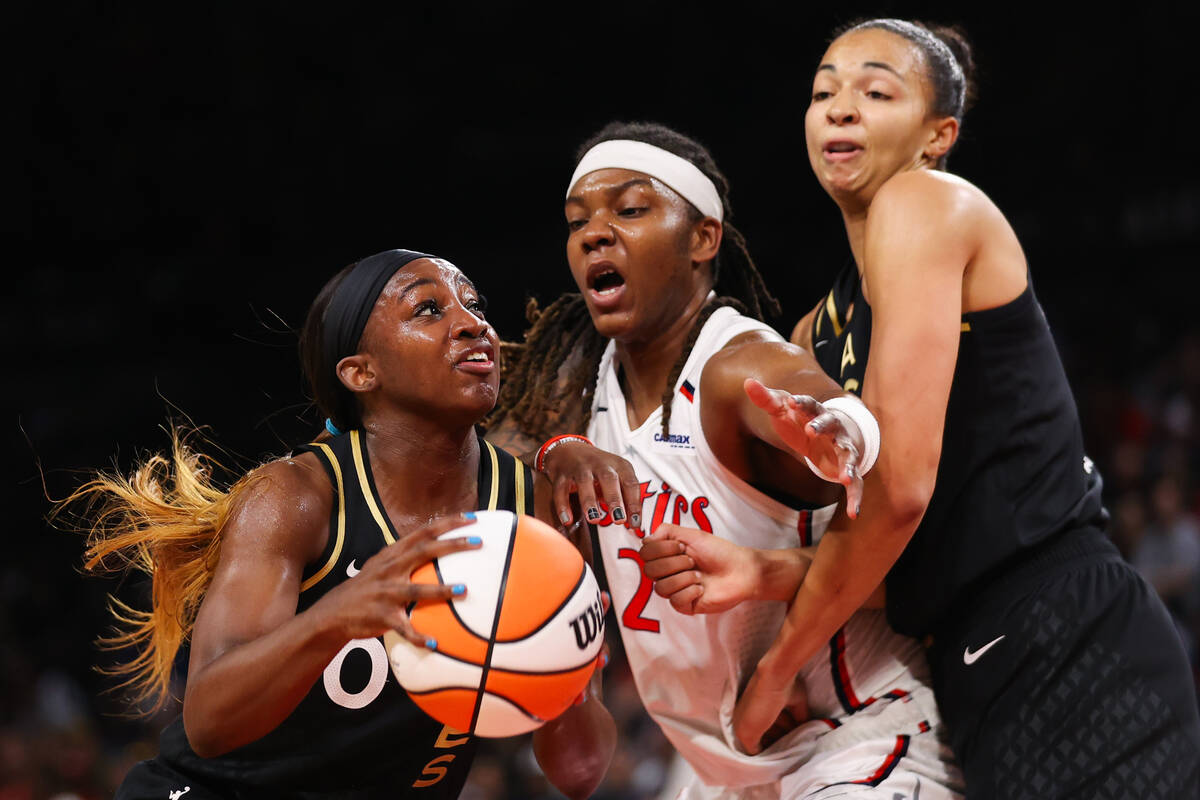 Las Vegas Aces guard Jackie Young (0) pushes past Washington Mystics forward Myisha Hines-Allen ...