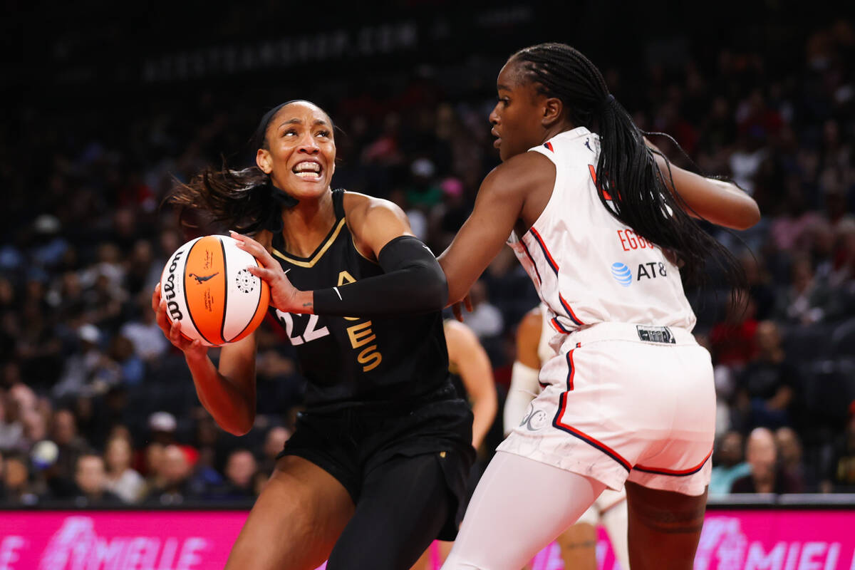 Las Vegas Aces forward A'ja Wilson (22) moves the ball past a Washington Mystics player during ...