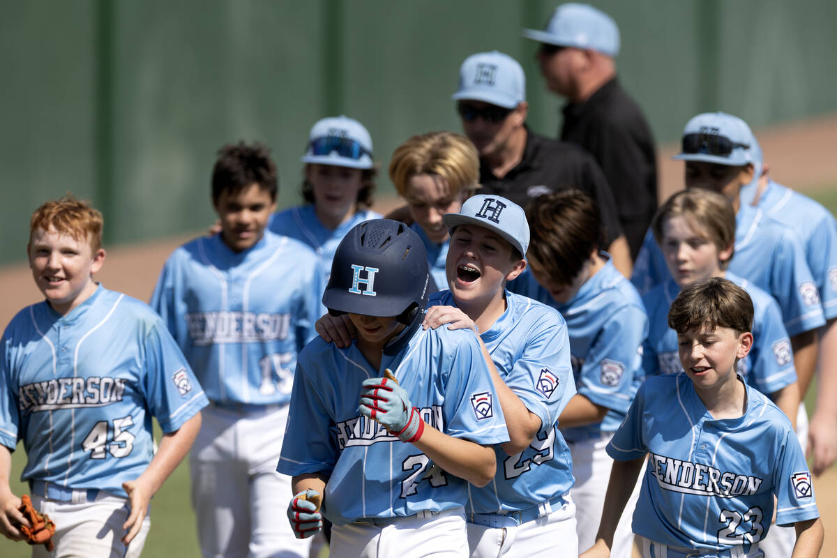 Henderson third baseman Logan Lavasseur (29) congratulates catcher Jaxson McMullin (24), who hi ...