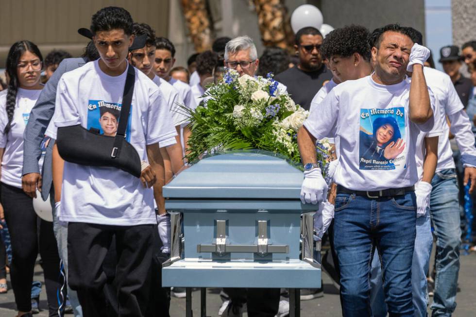 Rudolfo Naranjo, right, is overcome with emotions as he, his son Arley and others wheel the cas ...