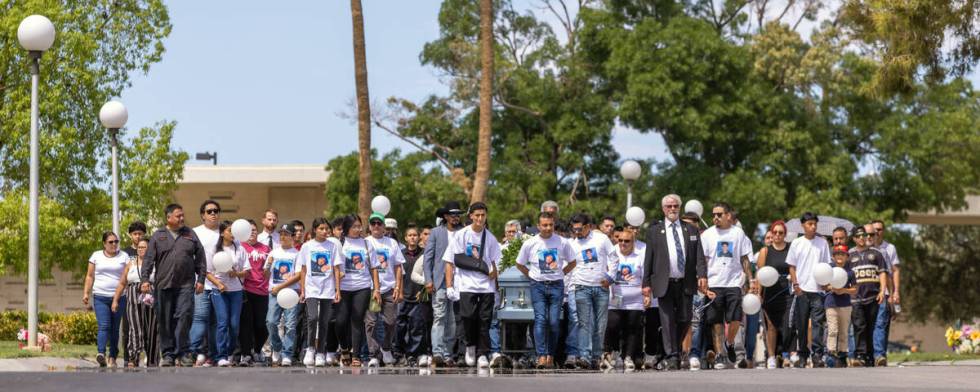 Rudolfo Naranjo, center, and son Arley with others wheel the casket of his son Angel from the c ...