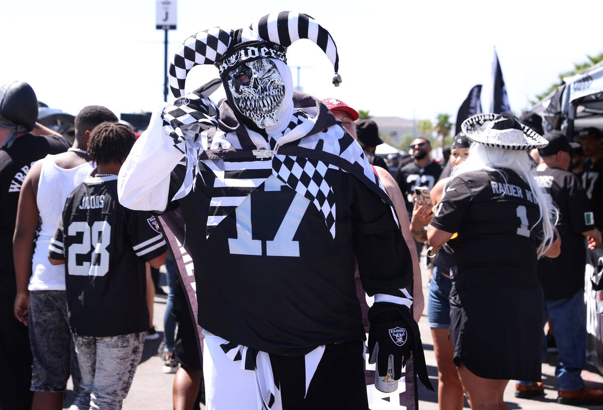 A Raiders fan is ready for the action before the first preseason NFL game at Allegiant Stadium ...