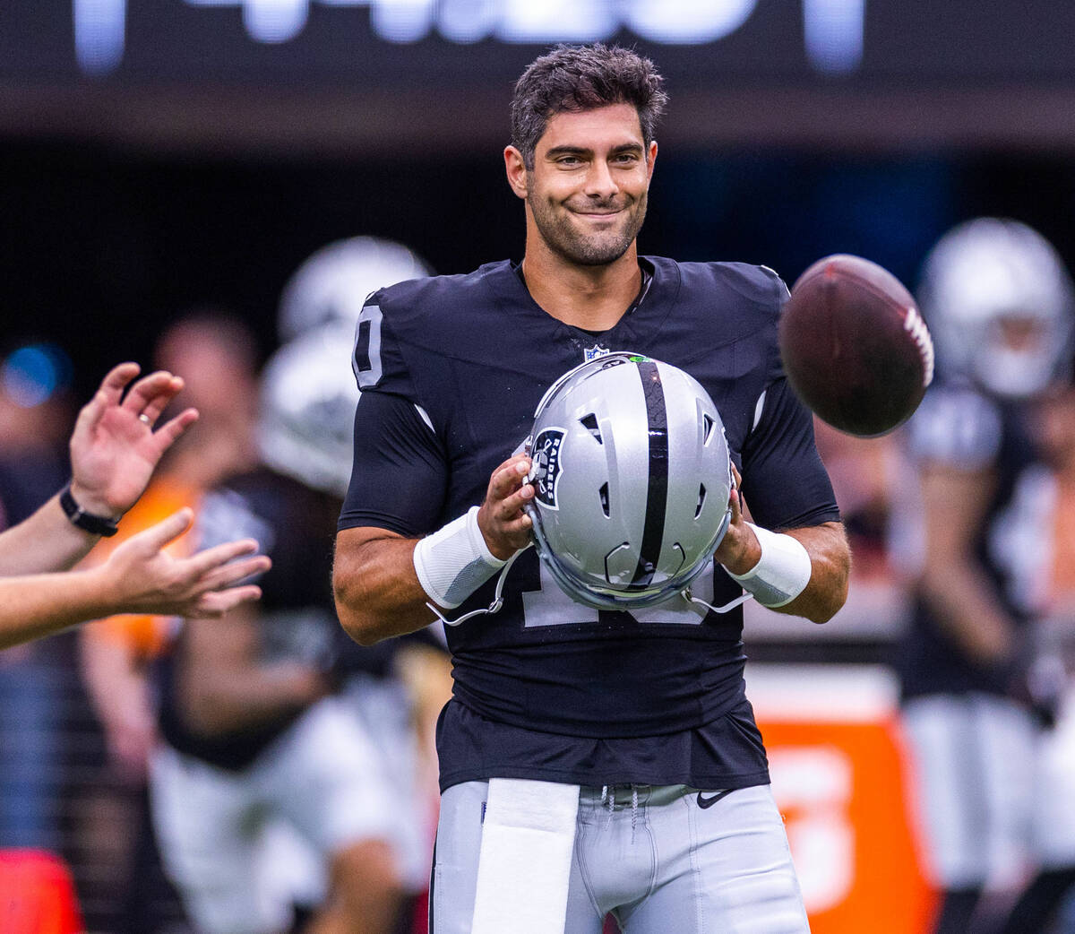 Raiders quarterback Jimmy Garoppolo (10) looks on and smiles during warm-ups before the first p ...