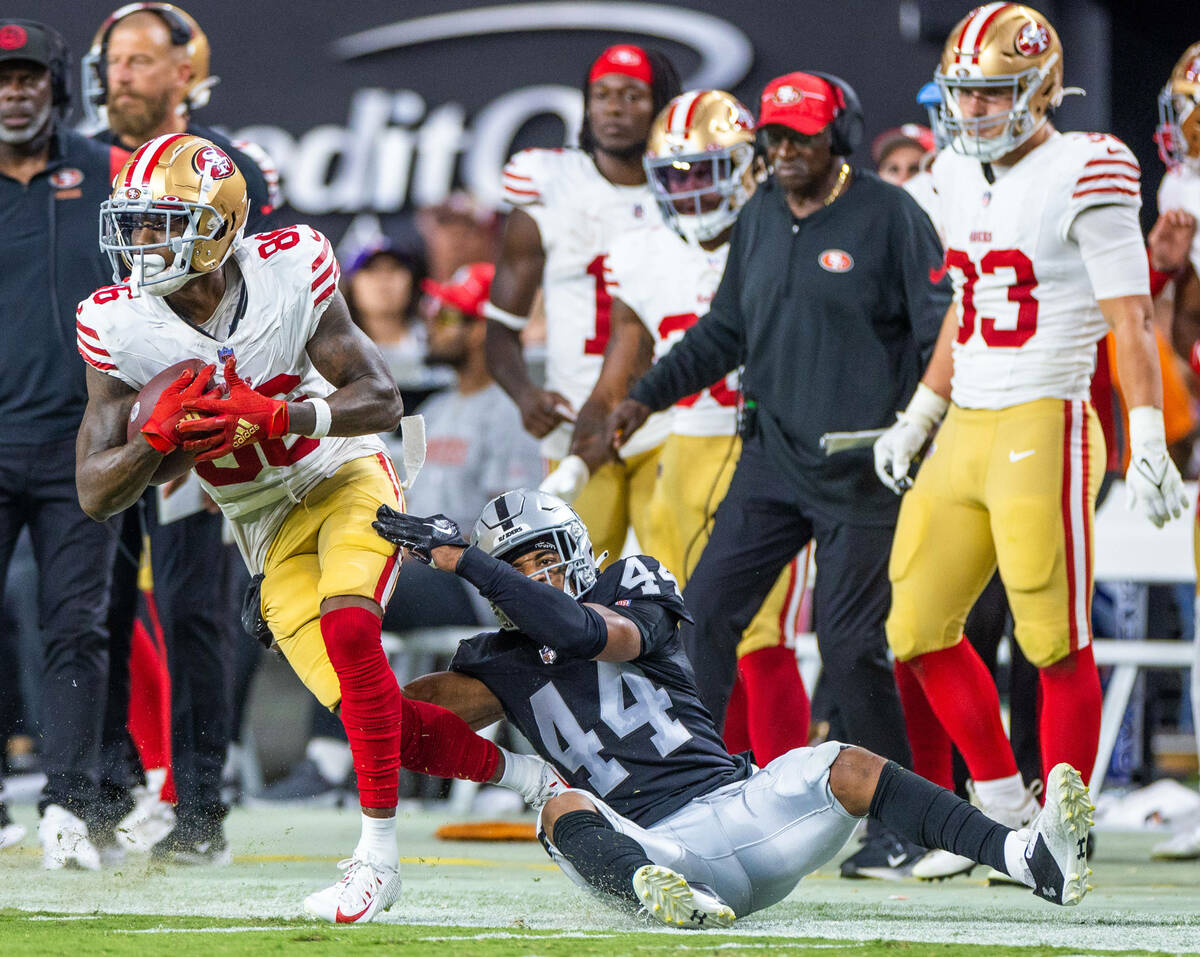 San Francisco 49ers wide receiver Tay Martin (86) is taken down along the sidelines by Raiders ...