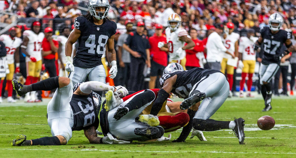 Raiders linebacker Curtis Bolton (36) and safety Chris Smith II (42) team up to tackle San Fran ...