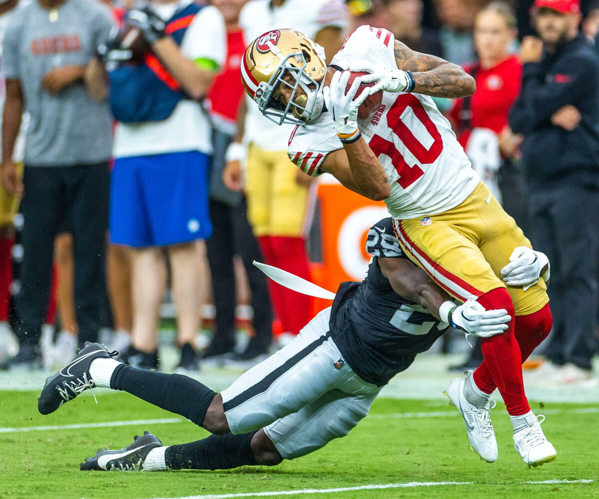 San Francisco 49ers wide receiver Ronnie Bell (10) is stopped on a punt return by Raiders corne ...