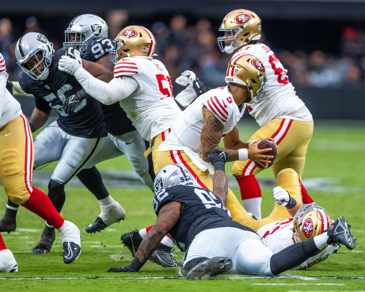 Raiders defensive tackle Neil Farrell Jr. (92) reaches out to stop San Francisco 49ers quarterb ...