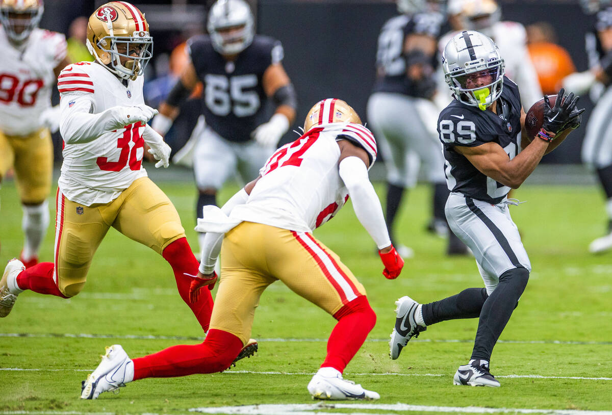 Raiders wide receiver Tre Tucker (89) looks to avoid a tackle by San Francisco 49ers corner bac ...
