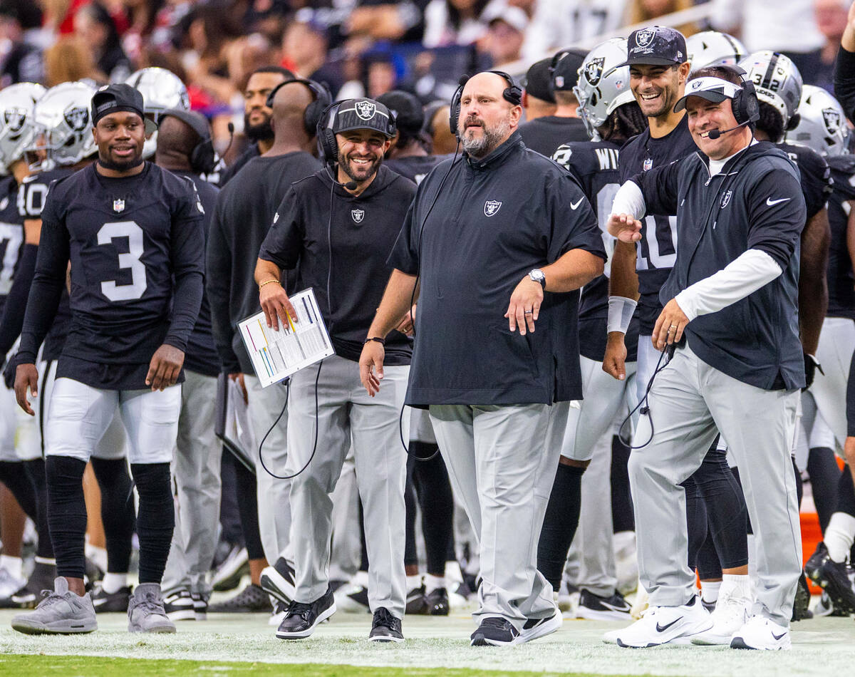Raiders head coach Josh Mcdaniels jokes with quarterback Jimmy Garoppolo (10) on the sidelines ...