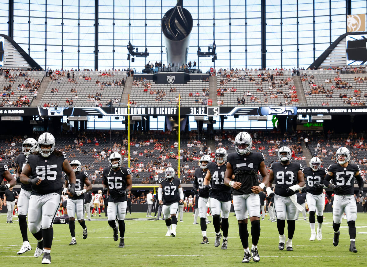 Raiders players take the field to face the San Francisco 49ers in an NFL preseason football gam ...