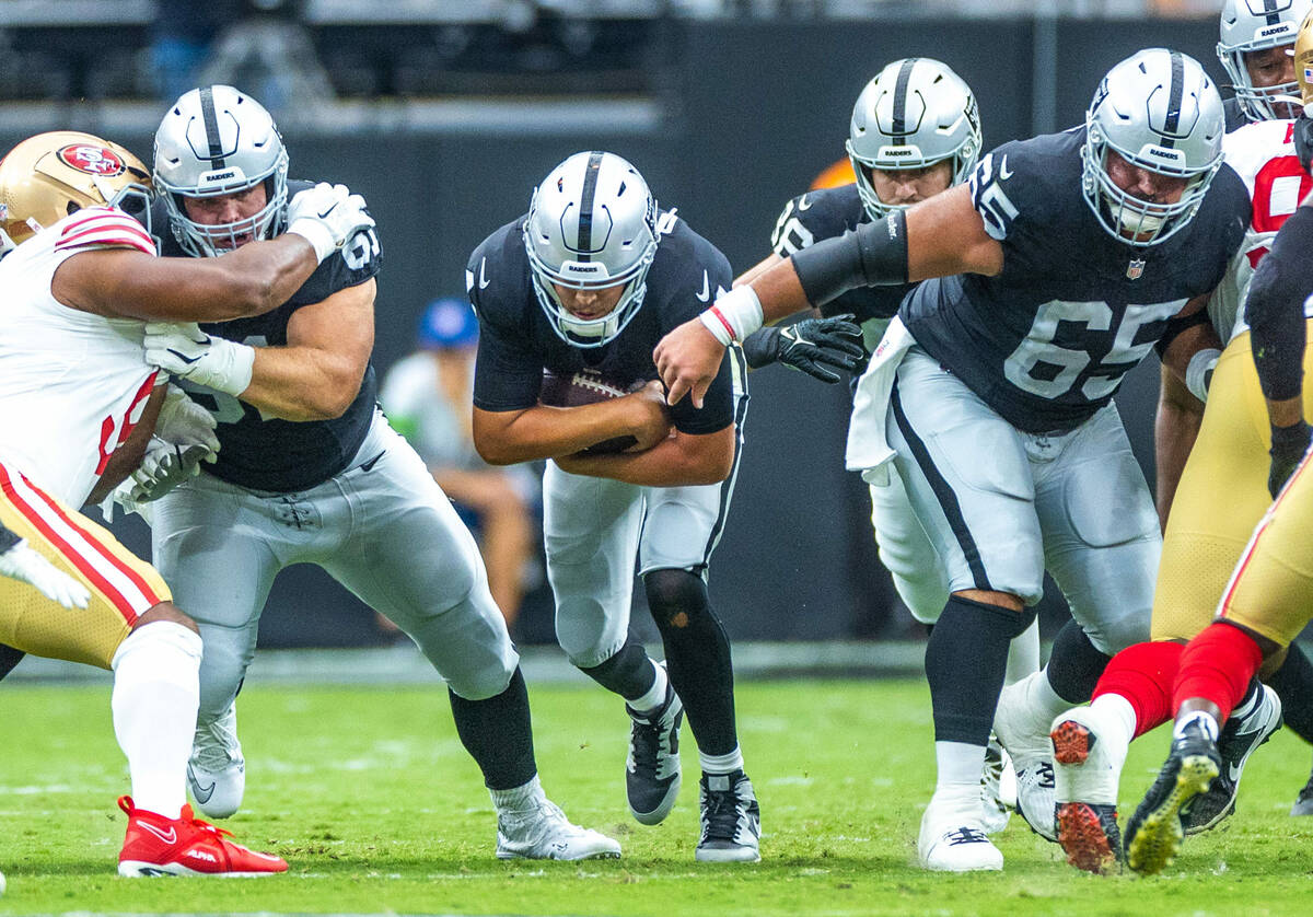 Raiders quarterback Aidan O'Connell (4) sneaks ahead for a first down against the San Francisco ...