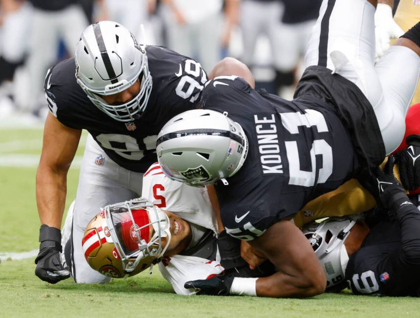 San Francisco 49ers quarterback Trey Lance (5) is tackled by Las Vegas Raiders defensive end Ma ...