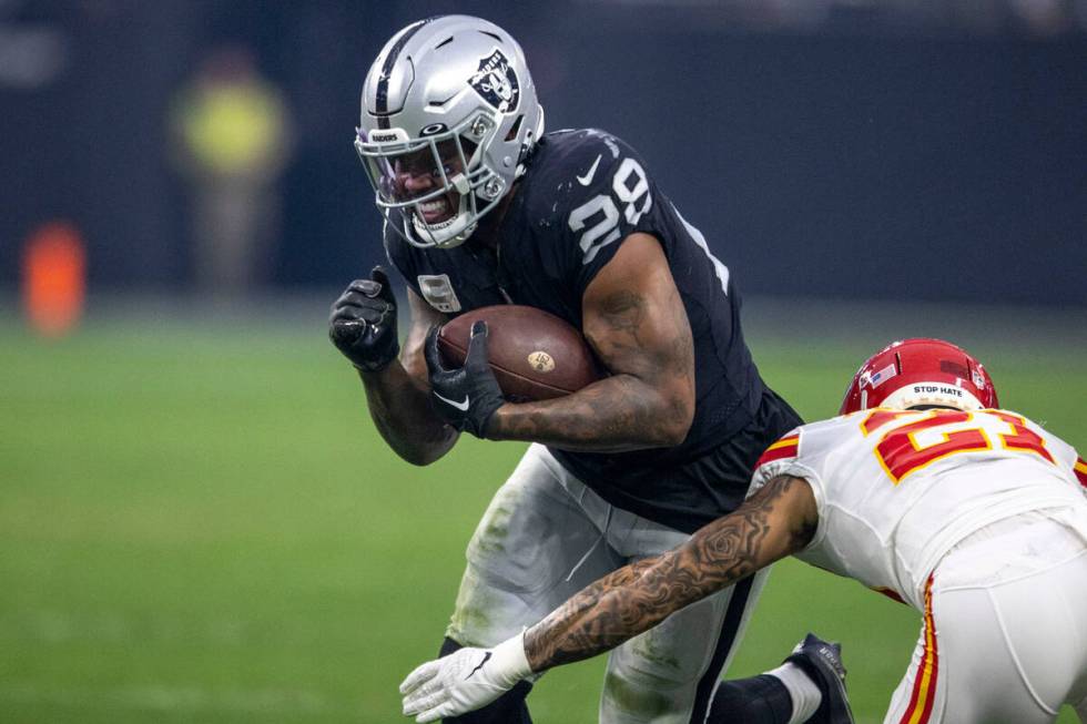 Raiders running back Josh Jacobs (28) rushes against Kansas City Chiefs cornerback Trent McDuff ...