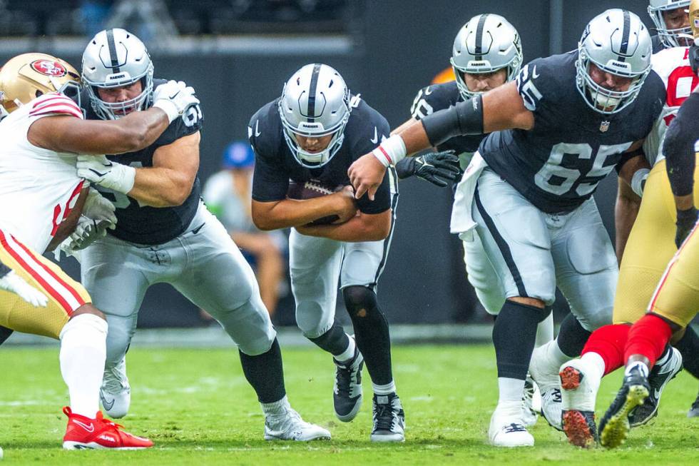 Raiders quarterback Aidan O'Connell (4) sneaks ahead for a first down against the San Francisco ...