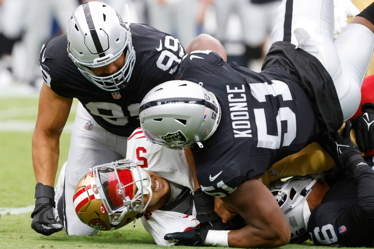 San Francisco 49ers quarterback Trey Lance (5) is tackled by Las Vegas Raiders defensive end Ma ...