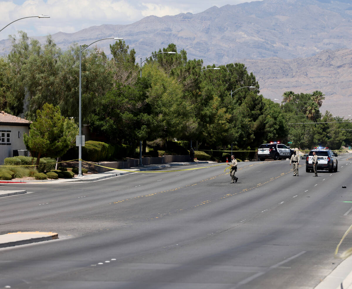 Las Vegas police investigate the scene of a fatal crash on North Tenaya Way near West Centennia ...