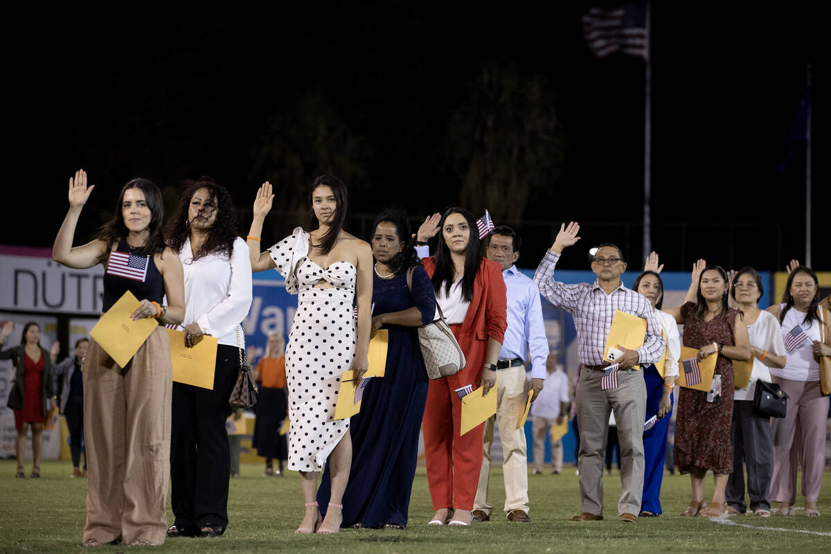 New U.S. citizens take the field during halftime of a Las Vegas Lights soccer game in a natural ...