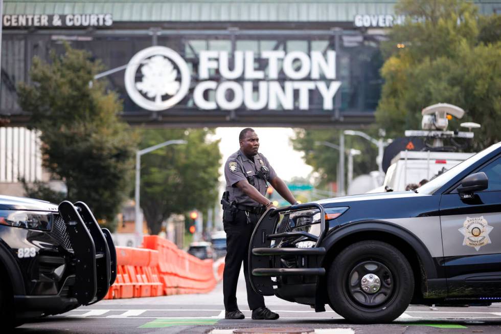 A sheriff's deputy looks on near the Fulton County Courthouse, Monday, Aug. 14, 2023, in Atlant ...