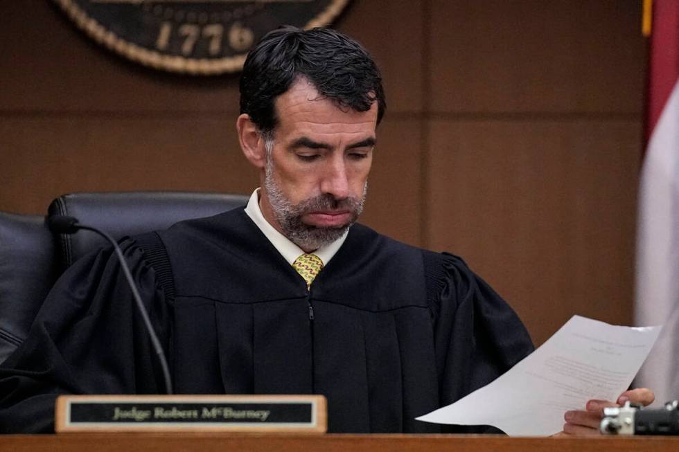 Fulton County Superior Court Judge Robert McBurney looks through paperwork, Monday, Aug. 14, 20 ...