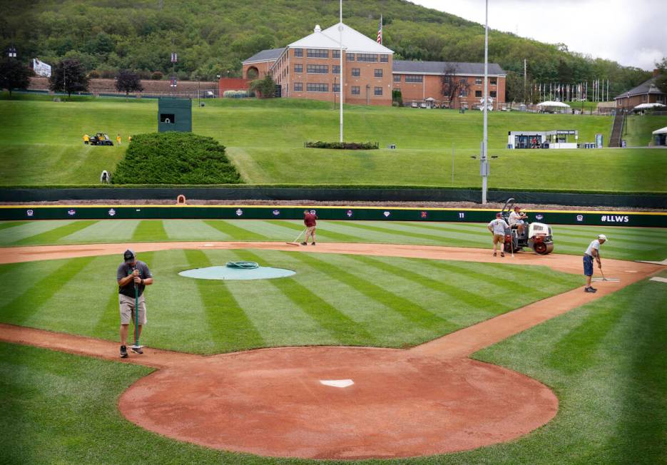 Ground crews workers prepare the field for the Little League World Series at Howard J. Lamade S ...