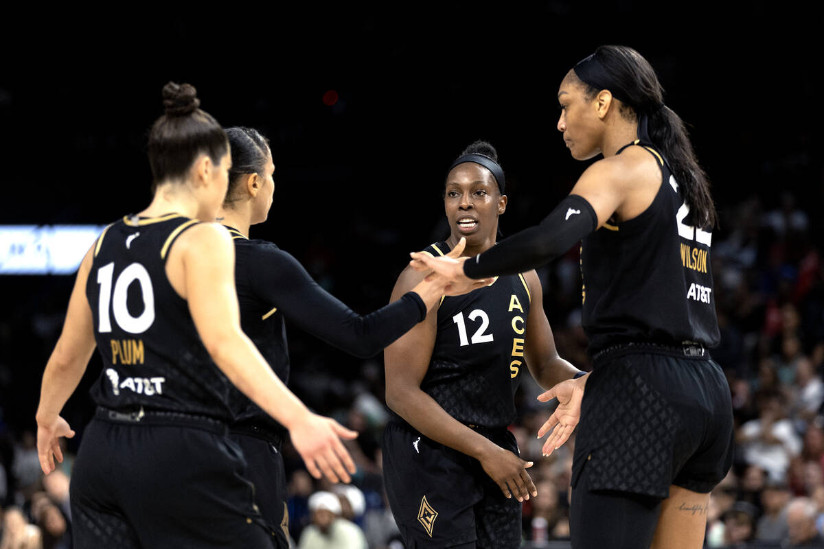 The Las Vegas Aces gather to slap hands during the first half of a WNBA basketball Commissioner ...