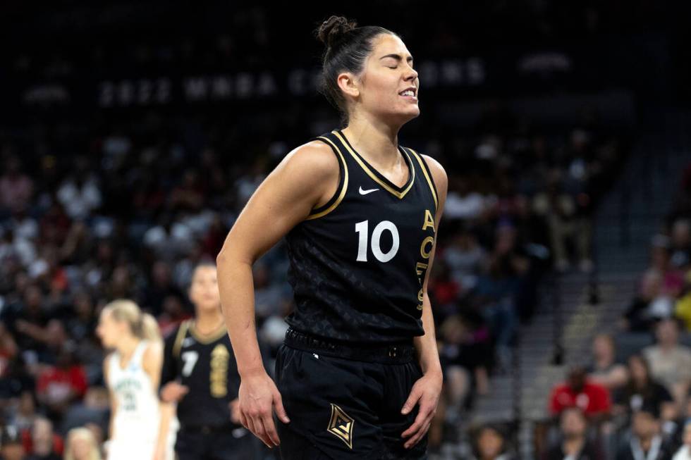 Las Vegas Aces guard Kelsey Plum (10) grimaces after falling to the court during the first half ...