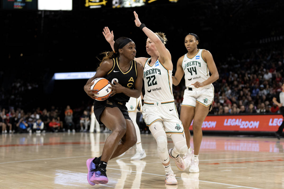 Las Vegas Aces guard Jackie Young (0) drives around New York Liberty guard Courtney Vandersloot ...