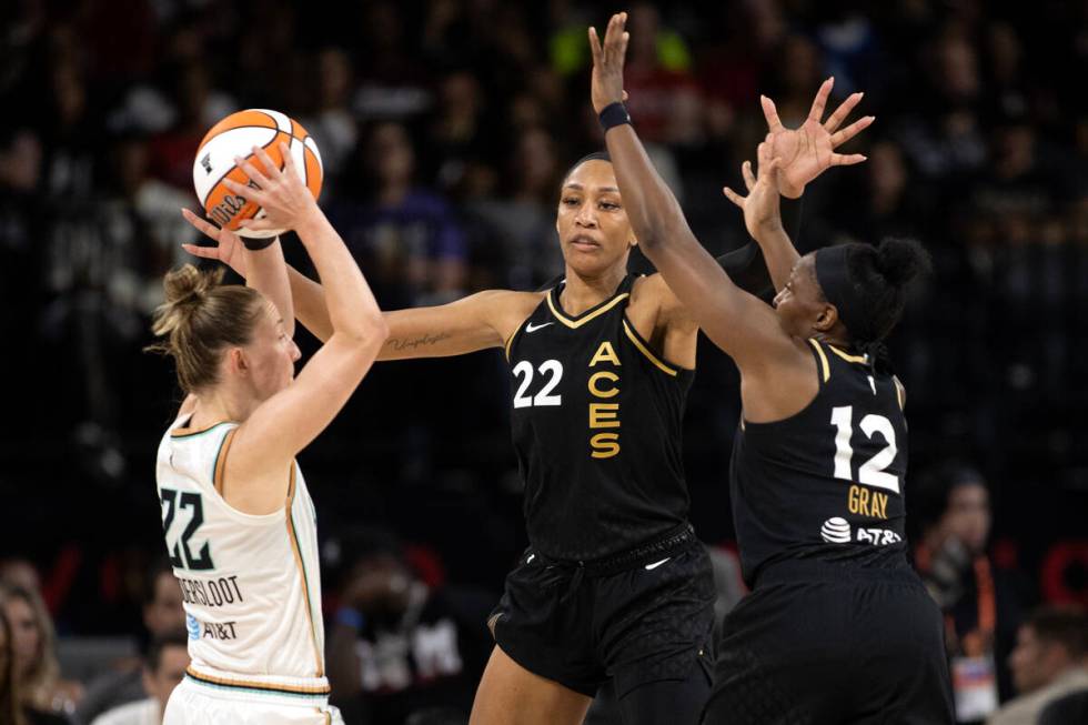 Las Vegas Aces forward A'ja Wilson (22) and guard Chelsea Gray (12) defend against New York Lib ...