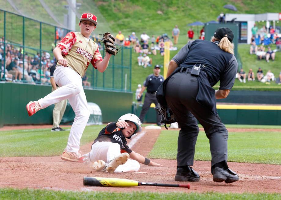 Rhode Island's John Wozniak is tagged out at home by the Henderson All-Stars pitcher Logan Leva ...