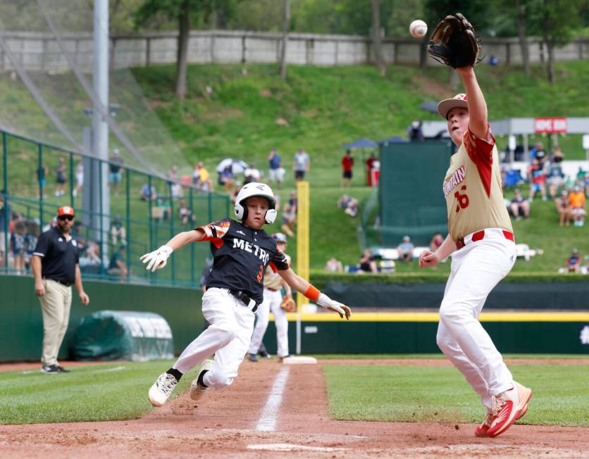 Rhode Island's Brady McShane (3) beats a throw and scores before Henderson All-Stars pitcher Lo ...