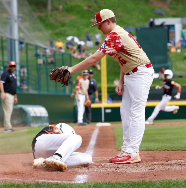 Rhode Island's Brayden Castellone beats a throw and scores before Henderson All-Stars pitcher L ...