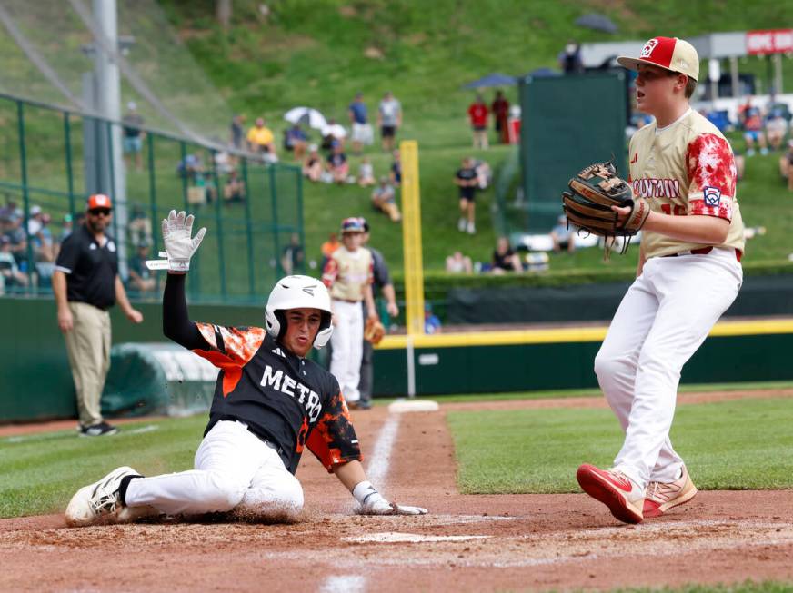 Rhode Island's Brayden Castellone beats a throw and scores before Henderson All-Stars pitcher L ...