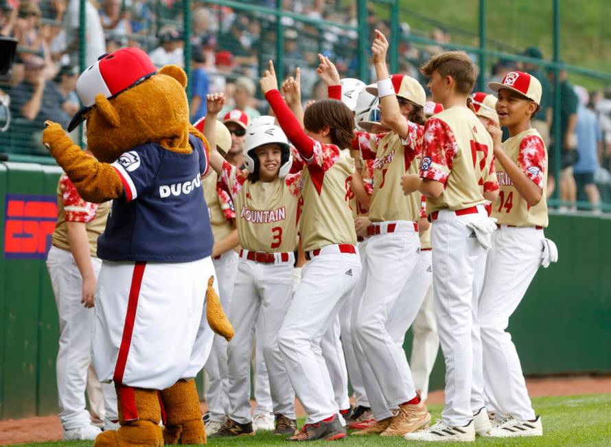 The Henderson All-Stars dance with Dugout, the official mascot of Little League baseball, prior ...