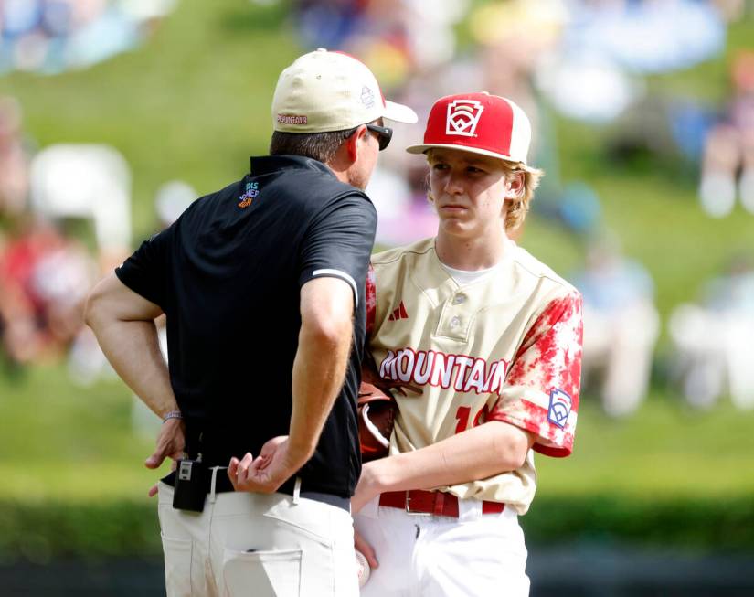 The Henderson All-Stars pitcher Nolan Gifford discusses with team manager Ryan Gifford on the m ...