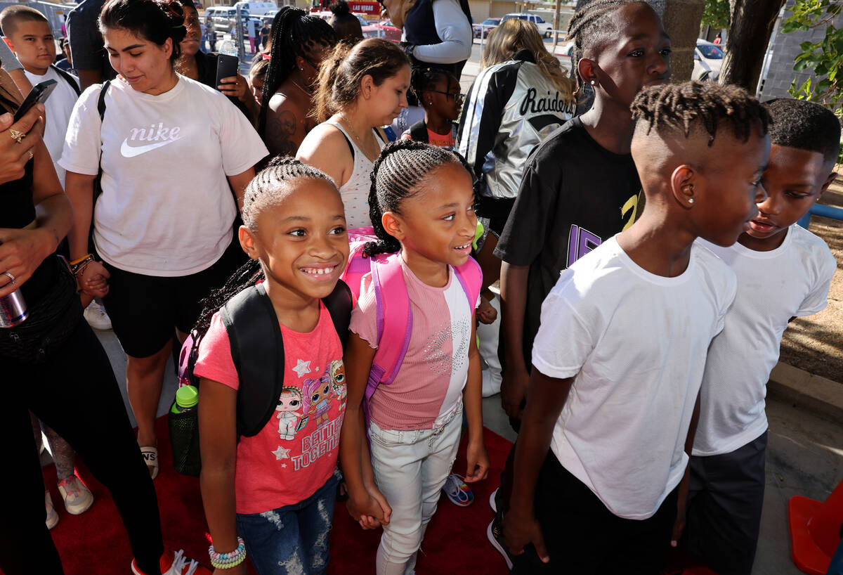 Fourth grade twins Mya Scott, left, and Nia Scott walk the red carpet during the annual &#x201c ...